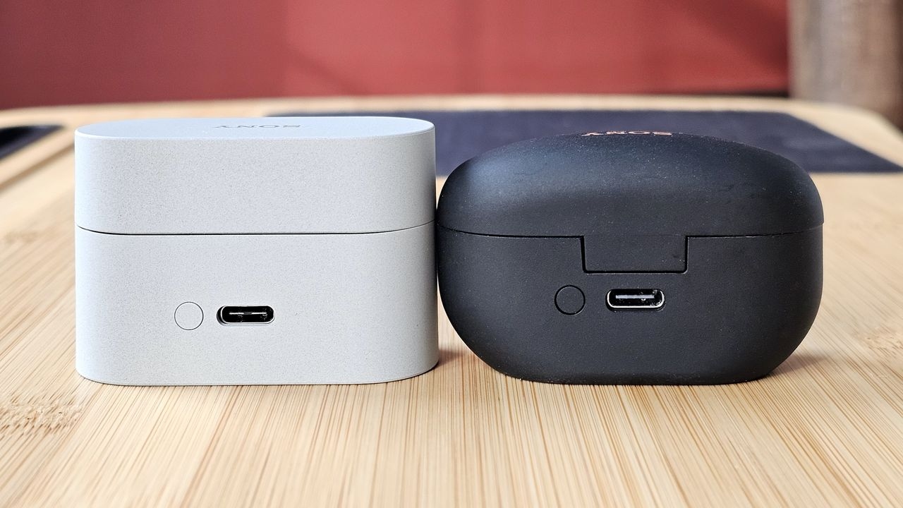The Sony WF-1000XM6 and WF-1000XM5 side by side in a comparison, on a light wood table