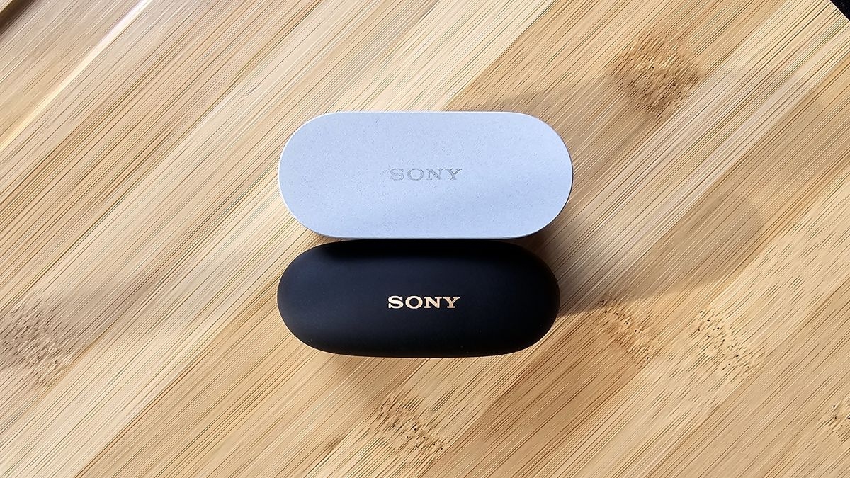 The Sony WF-1000XM6 and WF-1000XM5 side by side in a comparison, on a light wood table